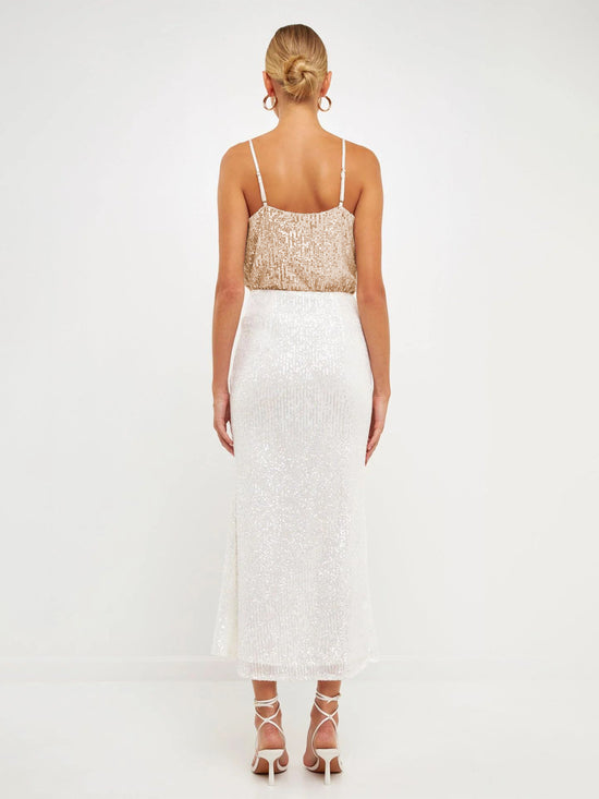Débardeur sequin tendance 2024 beige à fines bretelles porté de dos par une femme