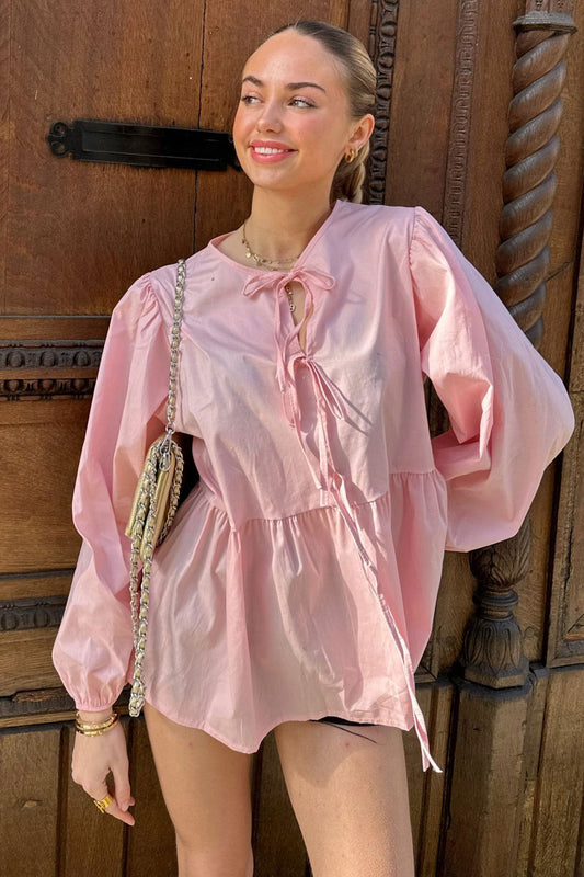 Haut scandinave femme tendance rose clair avec manches bouffantes et col noué élégant