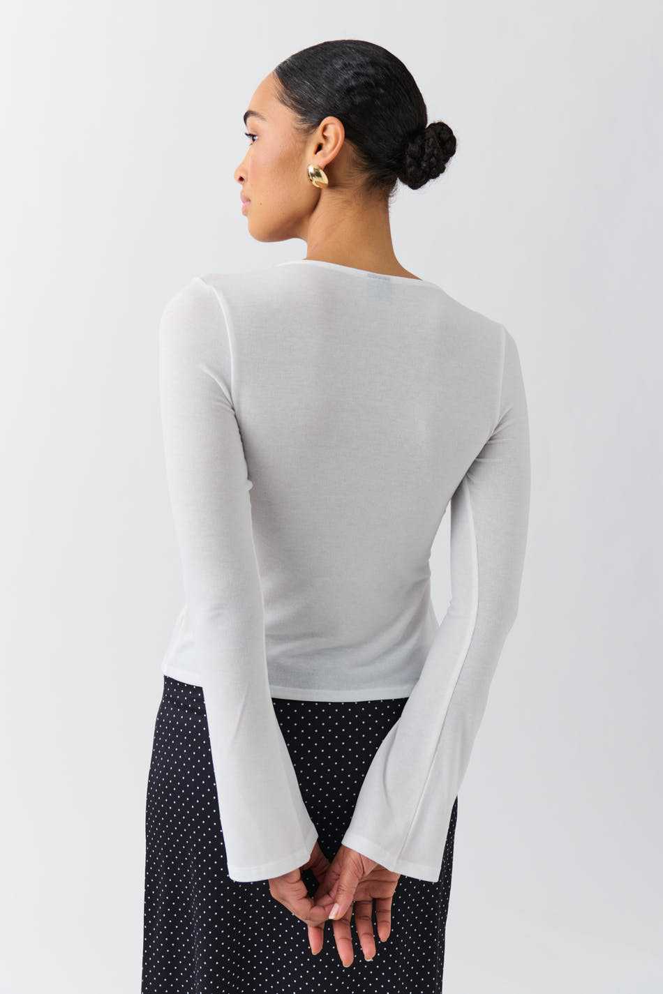 T-shirt style Stockholm pour femme blanc à manches longues et coupe ajustée vu de dos